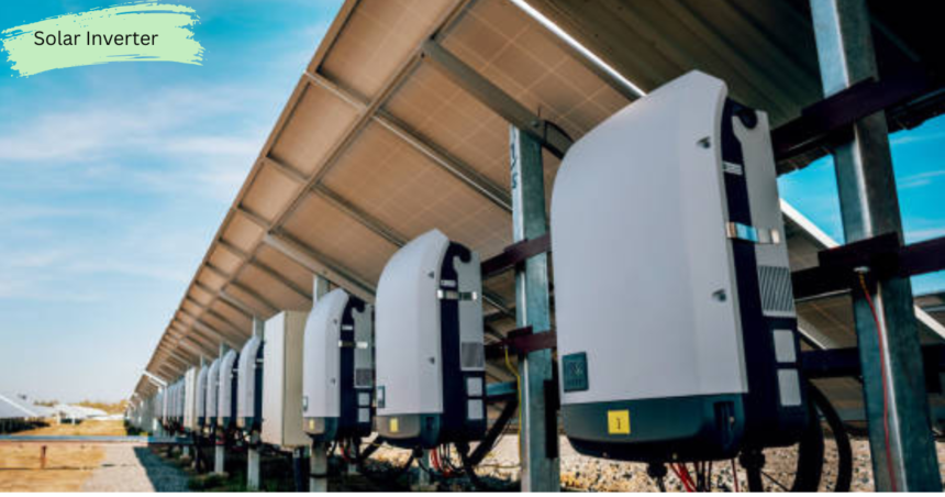 Large solar inverters installed beneath solar panel arrays in a commercial solar power plant