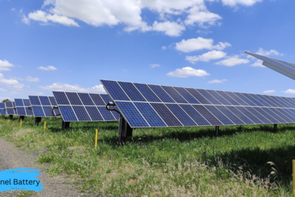 Solar Panel Battery system installed alongside a large solar panel array generating clean renewable energy under a clear blue sky.
