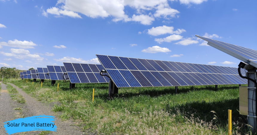 Solar Panel Battery system installed alongside a large solar panel array generating clean renewable energy under a clear blue sky.