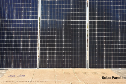 A detailed shot of JA Solar high efficiency solar panels set up on a rooftop for installation. This solar panel inverter system is shown in progress, designed to convert captured sunlight into usable AC power.