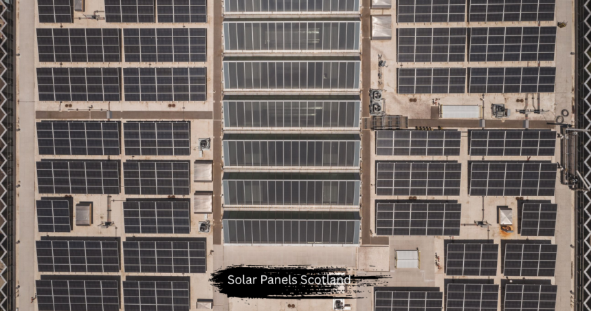 Aerial top down view of a massive commercial rooftop installation of solar panels Scotland, capturing clean renewable energy for sustainable power generation.