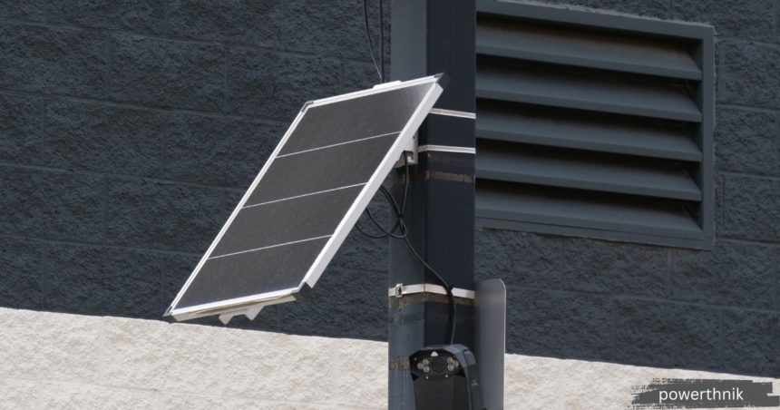 Solar Panel Inverter mounted with a solar panel on an exterior building wall, providing efficient DC to AC power conversion for a residential solar energy system.