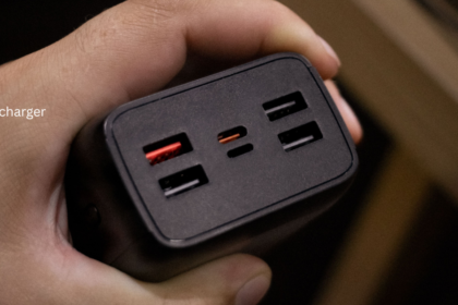 Hand holding a solar charger power bank with USB ports