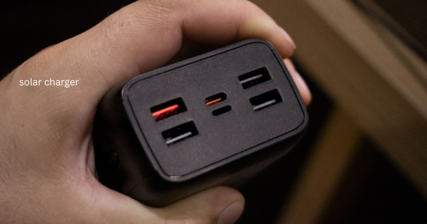 Hand holding a solar charger power bank with USB ports