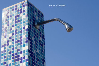 Mosaic tiled solar shower with chrome shower head against blue sky