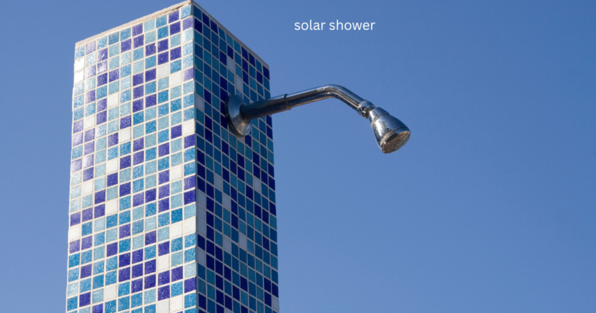 Mosaic tiled solar shower with chrome shower head against blue sky