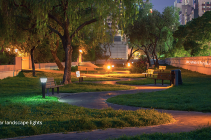 Best solar landscape lights illuminating a garden pathway with benches at night