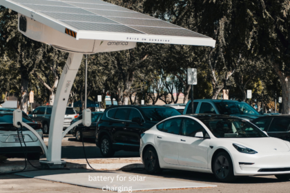 Battery for solar charging: solar-powered EV charging station with a white Tesla parked beside it