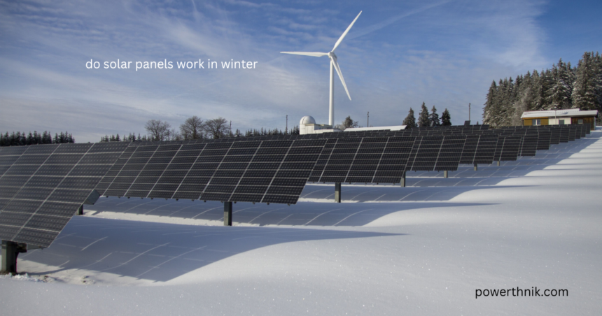 Large solar panel array generating electricity in a snowy field with wind turbine during winter