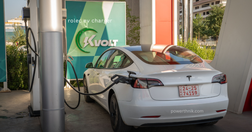 White Tesla Model 3 charging at Rolec EV charger station with KVOLT branding signage