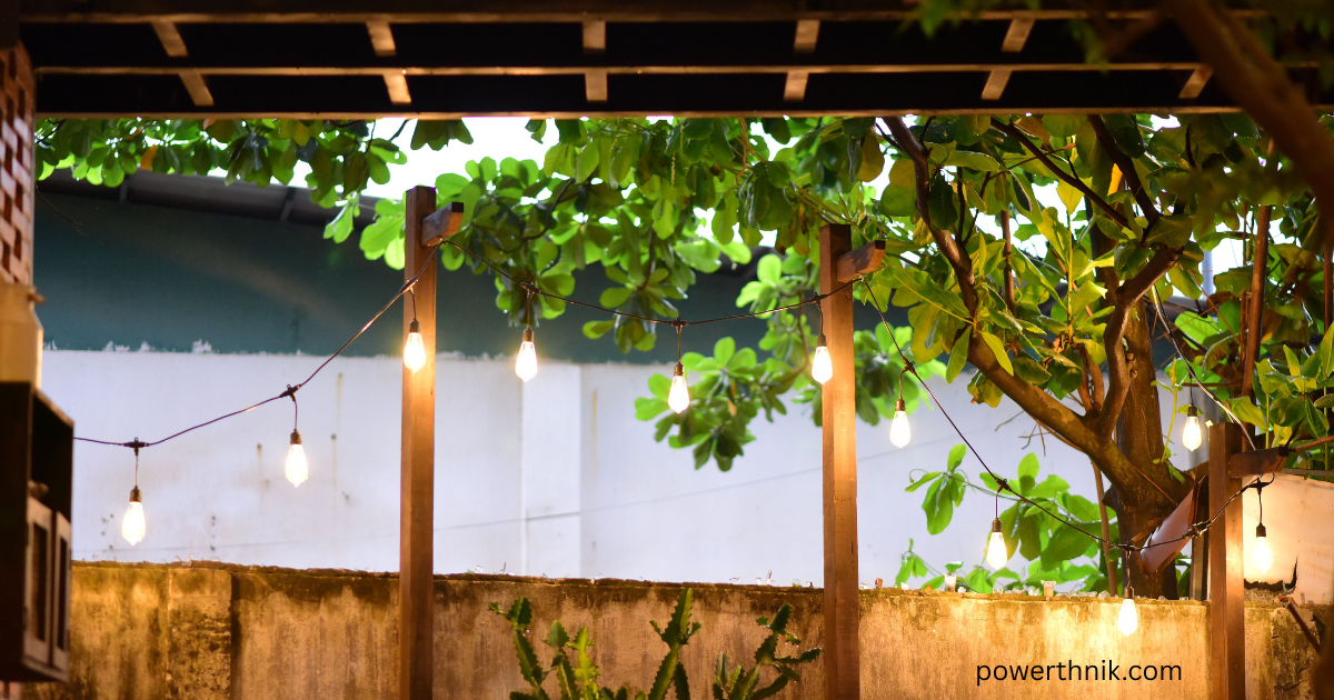 Waterproof Outdoor Fence Lights illuminating a wooden garden fence with warm evening light and greenery.