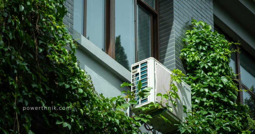A modern outdoor air source heat pump unit mounted on a building wall surrounded by green vines, professionally set up by air source heat pump installers.
