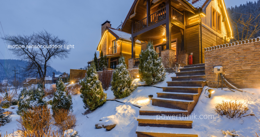 Motion sensor outdoor light illuminating snowy stone steps and a wooden chalet at dusk, with warm LED lights outlining the roof