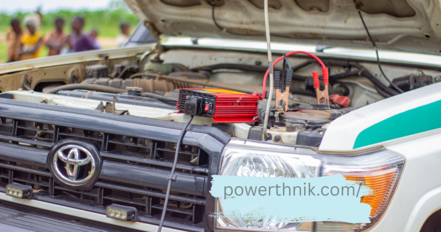 Red smart charger clamped to a Toyota battery, similar to charging a caravan leisure battery.