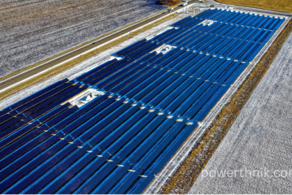 Lidl plug in solar panels style solar array in a snowy field beside a highway.
